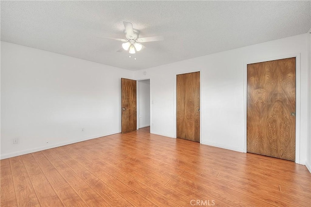 12460 Magnolia Ave, Chino, CA 91710 - unfurnished bedroom featuring a ceiling fan, a textured ceiling, baseboards, light wood finished floors, and multiple closets
