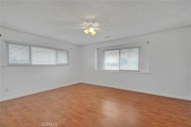 12460 Magnolia Ave, Chino, CA 91710 - unfurnished room featuring a wealth of natural light, visible vents, ceiling fan, and light wood-type flooring