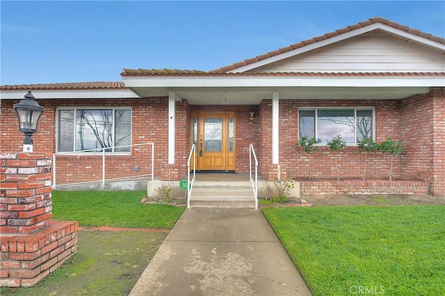 12460 Magnolia Ave, Chino, CA 91710 - view of front of home with a tiled roof, brick siding, and a front yard