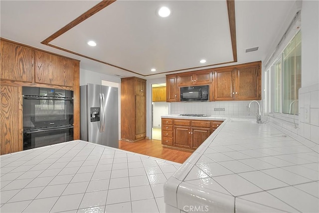 12460 Magnolia Ave, Chino, CA 91710 - kitchen featuring a sink, tile countertops, black appliances, and recessed lighting