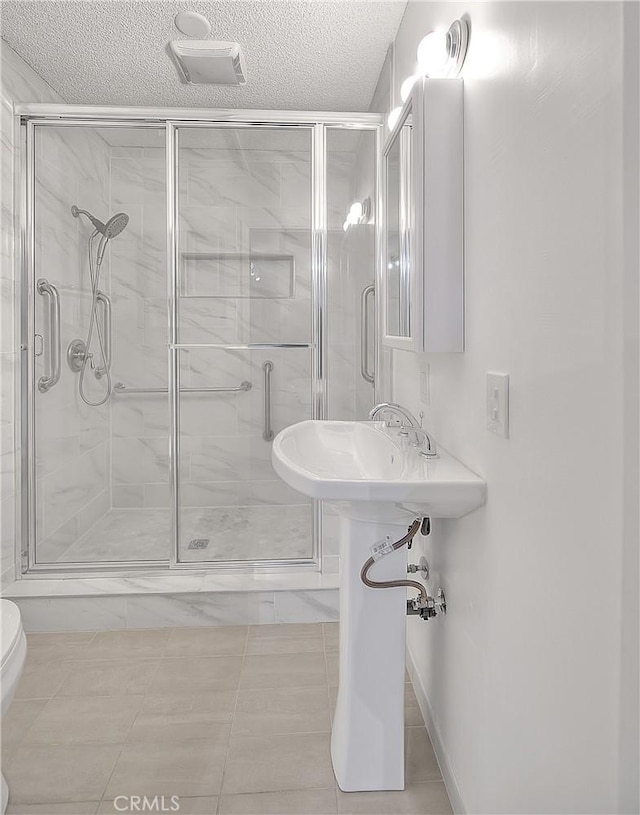 12460 Magnolia Ave, Chino, CA 91710 - full bathroom with toilet, a textured ceiling, and a shower stall