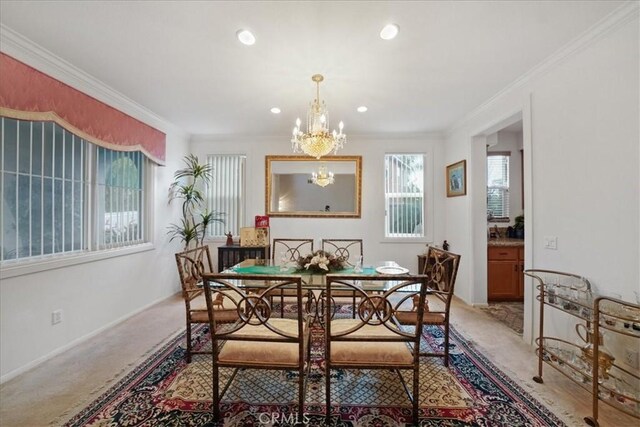 dining space featuring recessed lighting, light carpet, an inviting chandelier, and ornamental molding