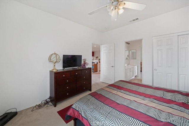 bedroom featuring visible vents, light carpet, a closet, and connected bathroom