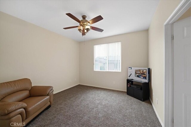 sitting room featuring baseboards, carpet, and ceiling fan