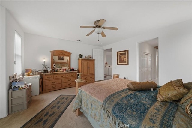 bedroom featuring a closet, light carpet, and ceiling fan