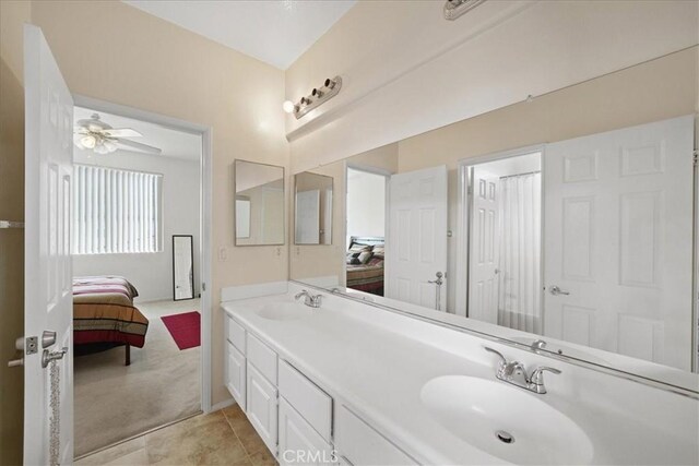 ensuite bathroom with a sink, double vanity, ceiling fan, and ensuite bathroom