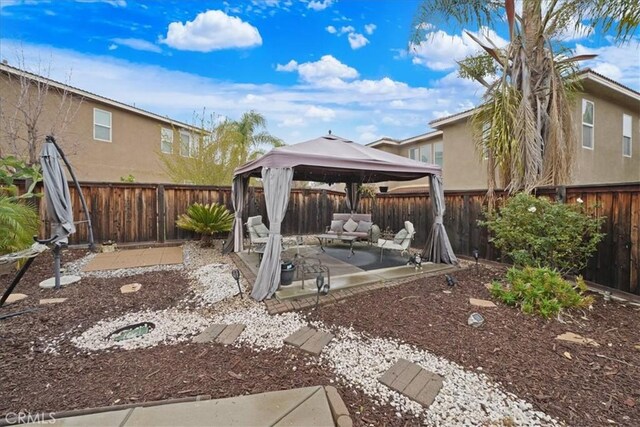 view of yard featuring a gazebo, a fenced backyard, and a patio