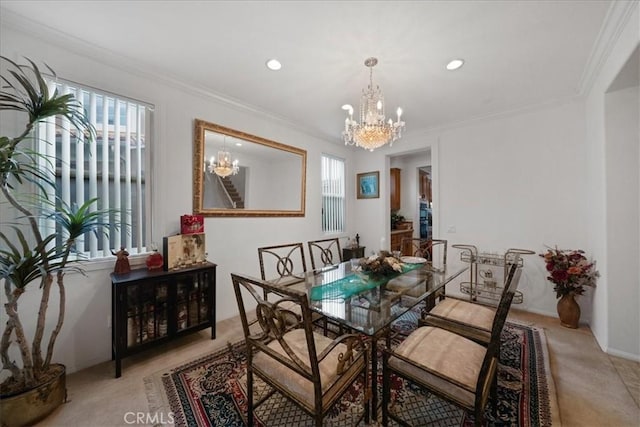 dining area featuring a healthy amount of sunlight, a chandelier, and crown molding