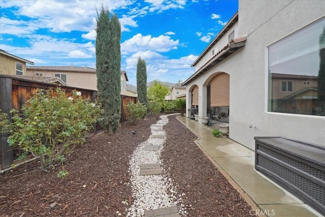 view of yard with a patio area, a residential view, and a fenced backyard