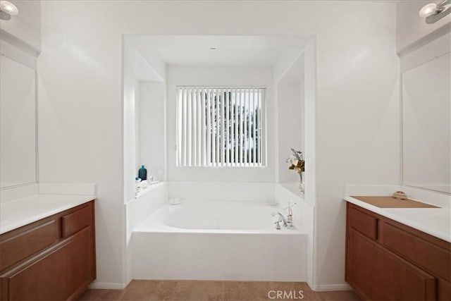 bathroom with vanity and a garden tub