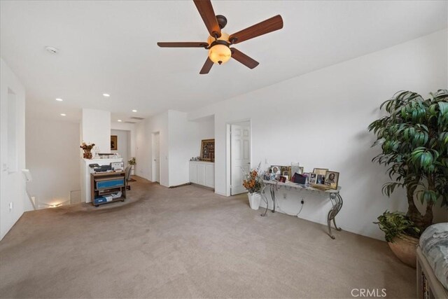 living room featuring recessed lighting, light colored carpet, and a ceiling fan