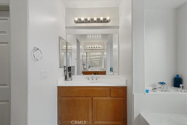 bathroom with a washtub and vanity