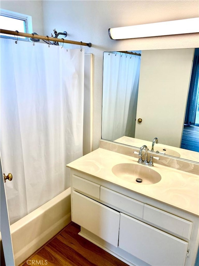 full bathroom with shower / bathtub combination with curtain, vanity, and wood finished floors