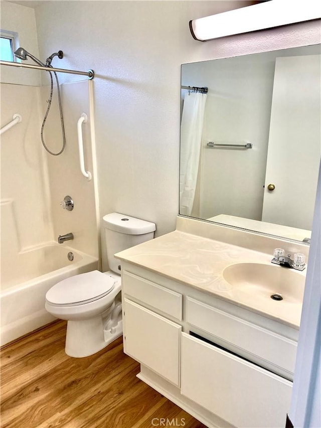 full bath with vanity, toilet, wood finished floors, and shower / tub combo with curtain