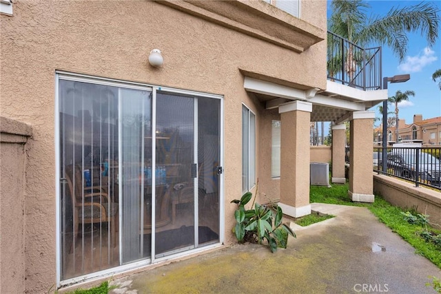 3119 Milano # J, Ontario, CA 91761 - entrance to property featuring stucco siding, a patio area, and fence