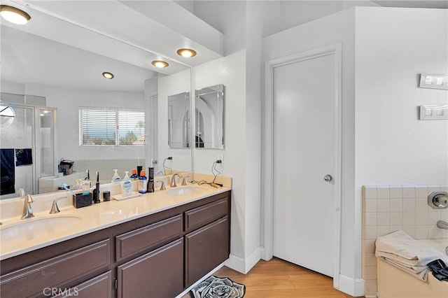 3119 Milano # J, Ontario, CA 91761 - full bath featuring double vanity, wood finished floors, a bath, and a sink