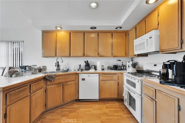 3119 Milano # J, Ontario, CA 91761 - kitchen with a sink, recessed lighting, white appliances, light wood-style floors, and a peninsula