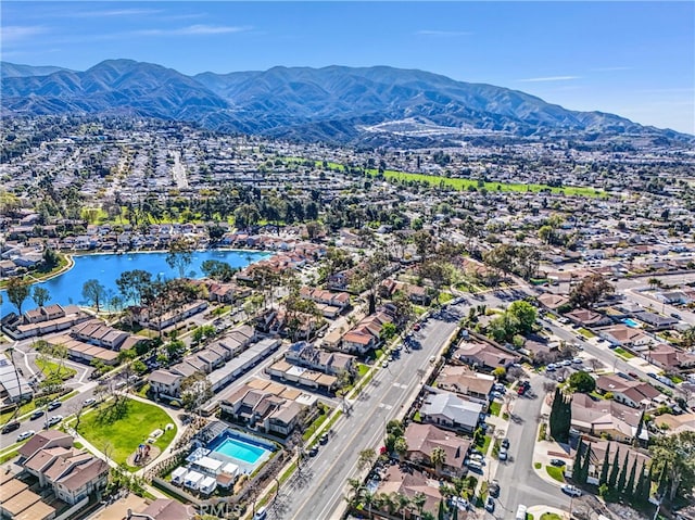 drone / aerial view with a residential view and a water and mountain view