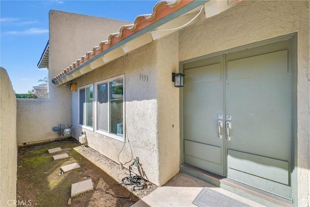 doorway to property with stucco siding