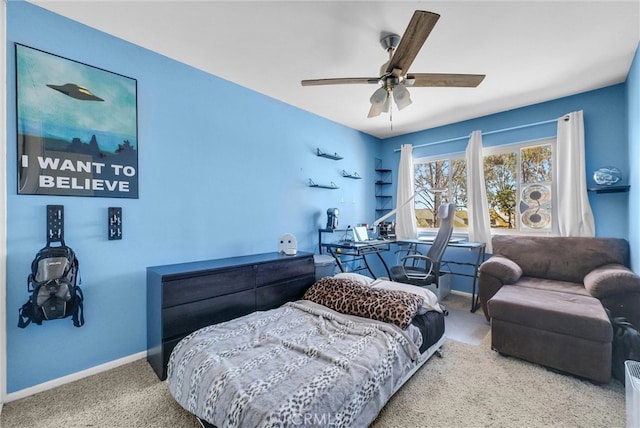 bedroom with ceiling fan, baseboards, and carpet