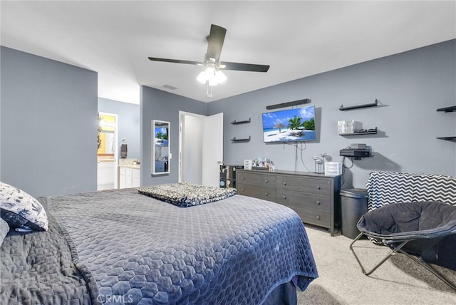 bedroom featuring visible vents, ensuite bathroom, carpet, and a ceiling fan