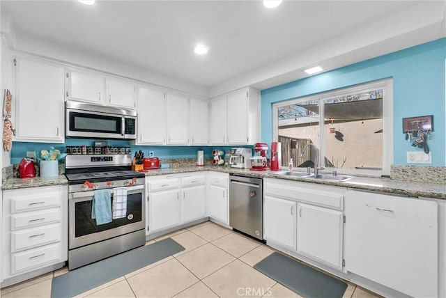 kitchen featuring white cabinetry, stainless steel appliances, and a sink