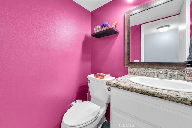 bathroom with toilet and vanity