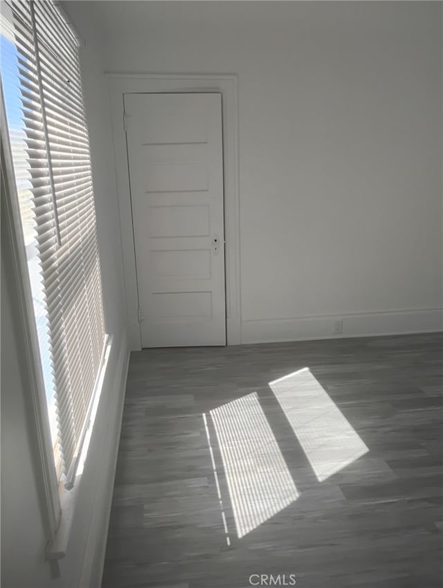 spare room with baseboards