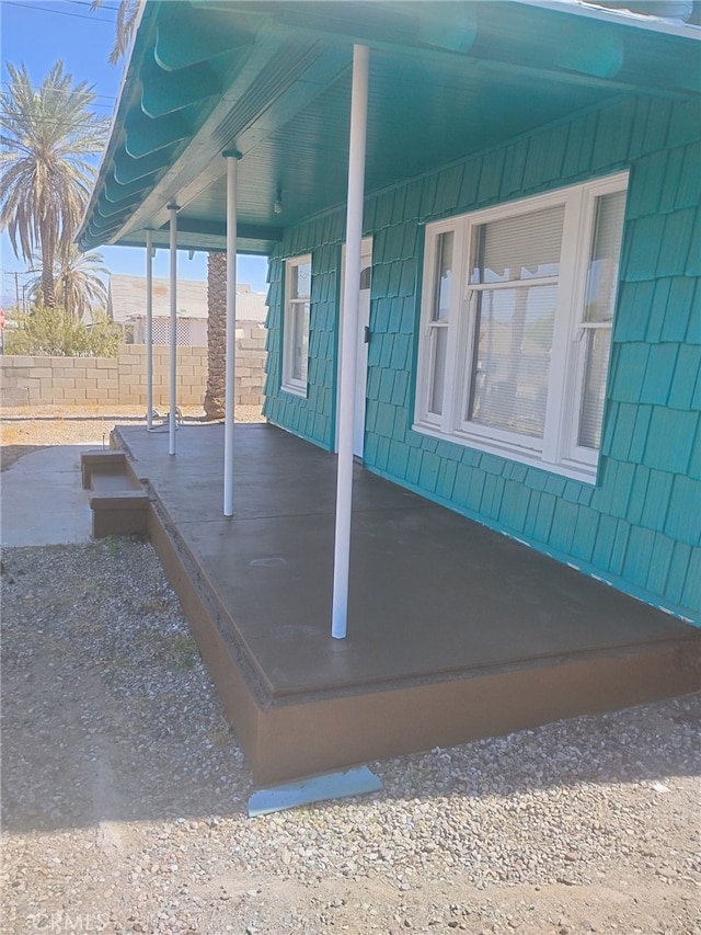 view of patio featuring fence