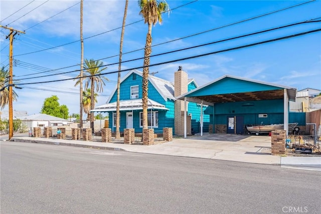 401 Cibola St, Needles, CA 92363 - view of building exterior featuring a detached carport and driveway