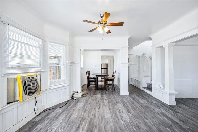 401 Cibola St, Needles, CA 92363 - dining space with ceiling fan, stairway, wood finished floors, decorative columns, and cooling unit