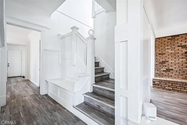 401 Cibola St, Needles, CA 92363 - staircase featuring brick wall and wood finished floors