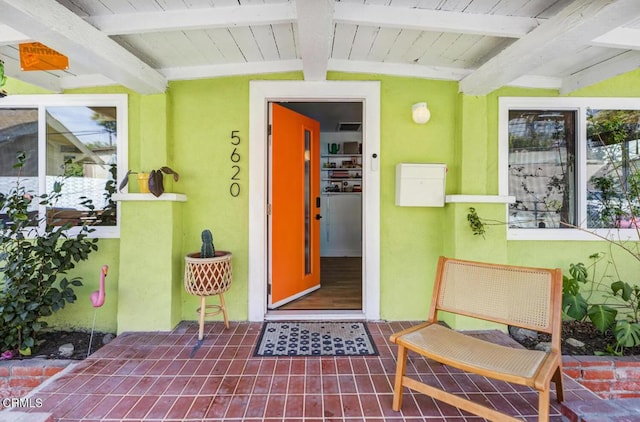 property entrance with stucco siding