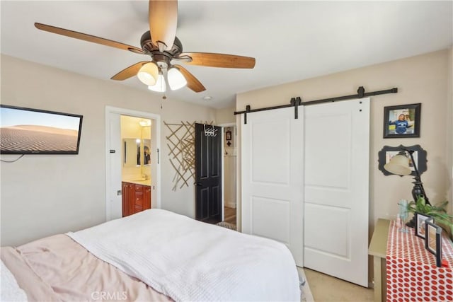 33971 Lily Rd, Yucaipa, CA 92399 - bedroom featuring a barn door, light carpet, connected bathroom, and a ceiling fan