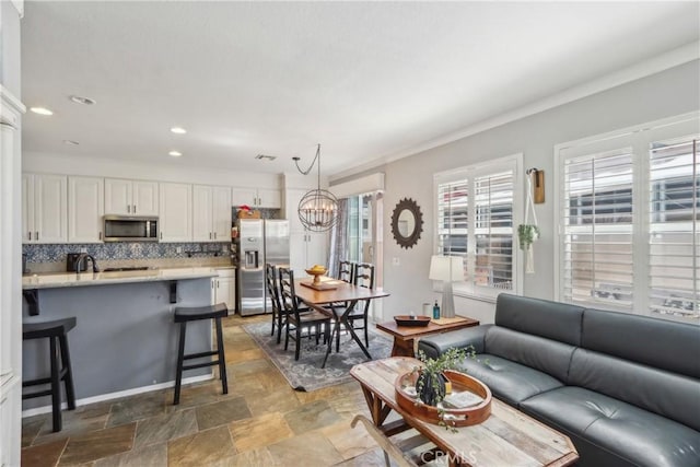 33971 Lily Rd, Yucaipa, CA 92399 - living area featuring stone finish flooring, a chandelier, and recessed lighting