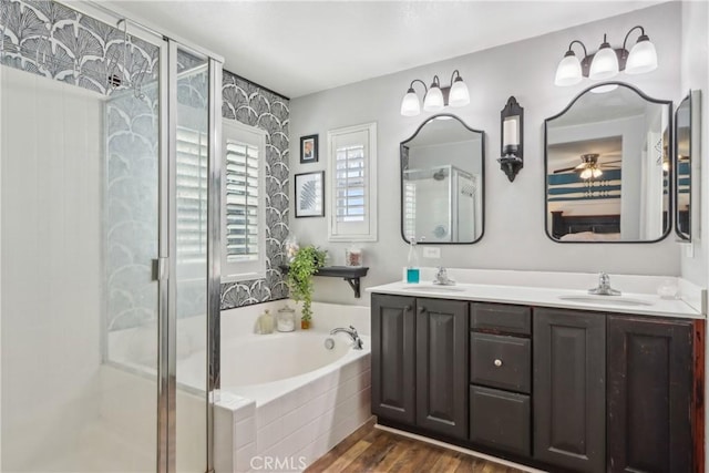 33971 Lily Rd, Yucaipa, CA 92399 - full bathroom with a bath, a shower stall, double vanity, and wood finished floors