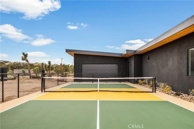 view of tennis court featuring fence