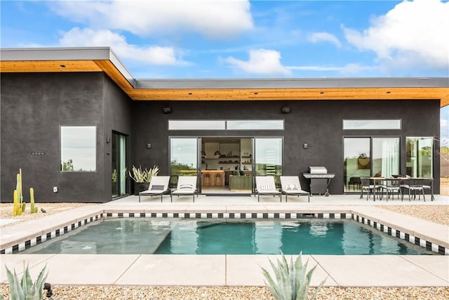 back of property featuring a patio and stucco siding