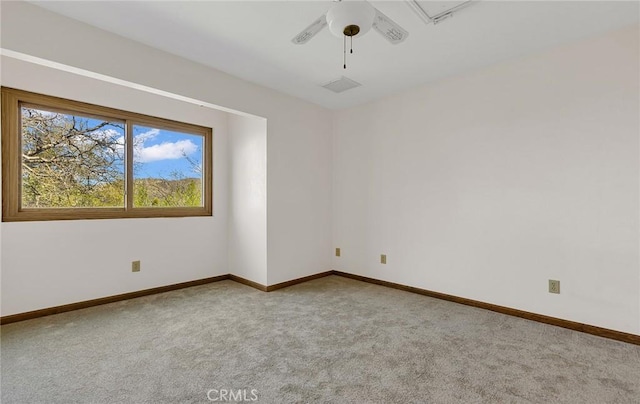 carpeted empty room featuring baseboards and ceiling fan