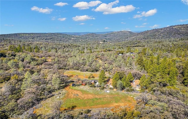 aerial view featuring a view of trees and a mountain view