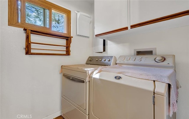 laundry area featuring washer and dryer and cabinet space