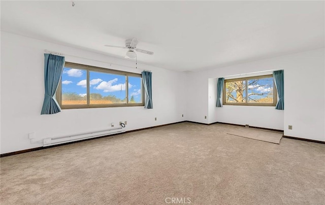 unfurnished room featuring baseboards, plenty of natural light, carpet, and a baseboard heating unit