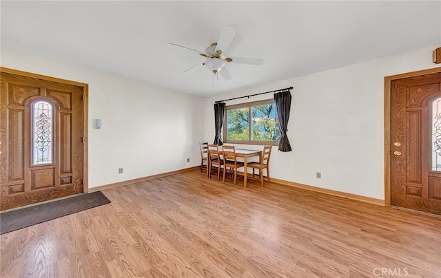 entrance foyer with light wood finished floors, a ceiling fan, and baseboards