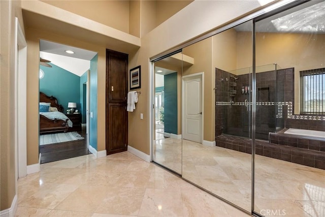 full bathroom with baseboards, tiled shower, a towering ceiling, ensuite bathroom, and a garden tub