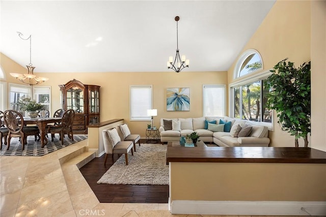 living room with an inviting chandelier and high vaulted ceiling