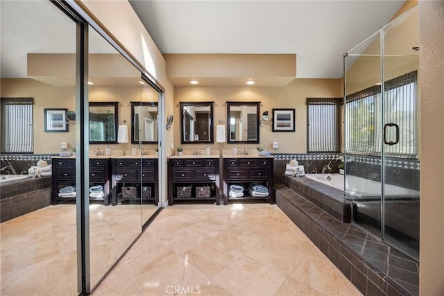 bathroom featuring vanity, a bath, and a stall shower