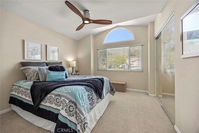 bedroom with baseboards, lofted ceiling, ceiling fan, and carpet flooring