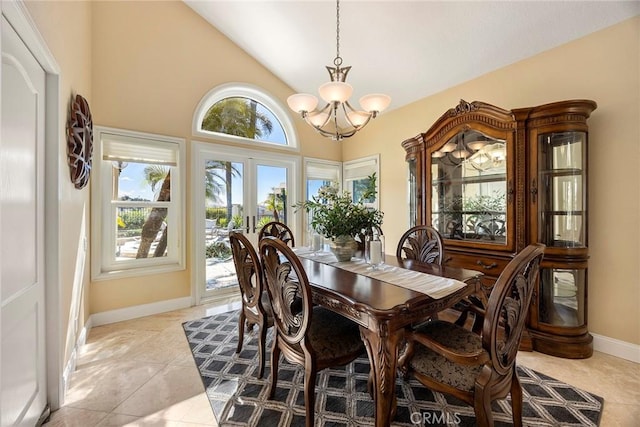 dining space with high vaulted ceiling, french doors, an inviting chandelier, light tile patterned floors, and baseboards