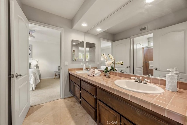 ensuite bathroom with a sink, visible vents, double vanity, and ensuite bathroom