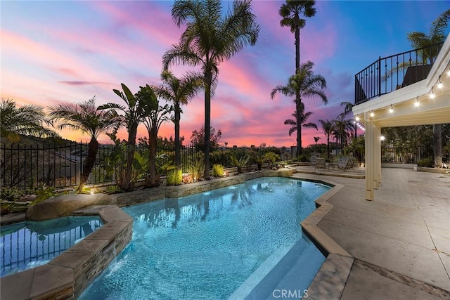 view of swimming pool featuring a fenced in pool, fence, and a patio area